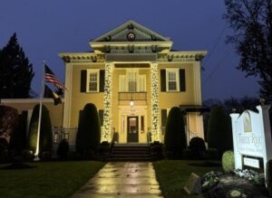 Commercial holiday lighting on a North Jersey business with column wraps and roofline lights