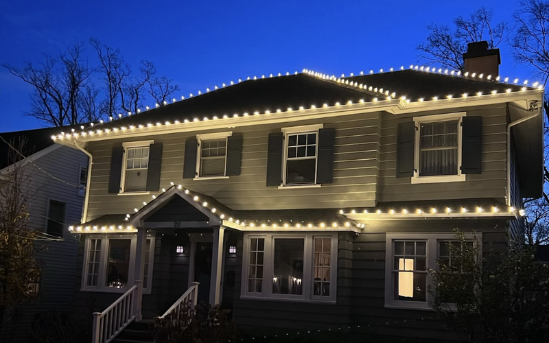 Classic Short Hills NJ colonial with warm white C9 lights along the roof and front porch
