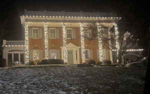 Brick Short Hills NJ home with column-wrapped Christmas lights and roofline C9 bulbs in the snow