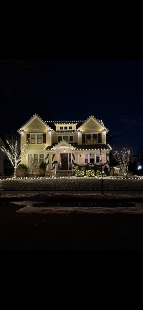 Short Hills NJ home with roofline lights, wrapped trees and lighted walkway edging