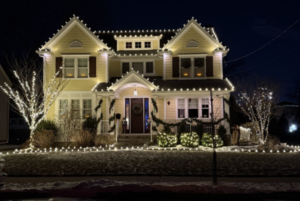 Short Hills NJ home with roofline lights, wrapped trees and lighted walkway edging