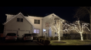 Short Hills NJ home with roofline C9 lights and two brightly wrapped front yard trees