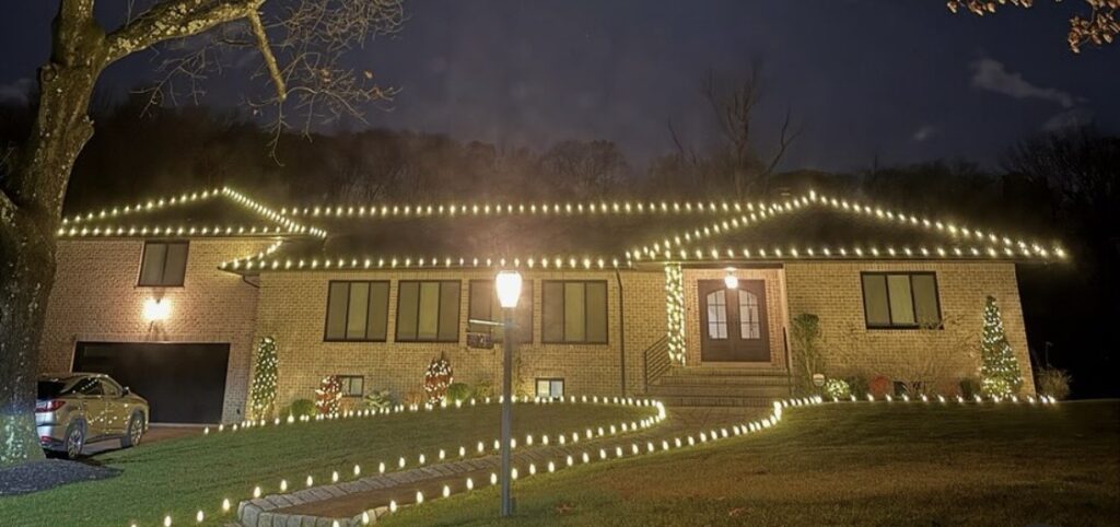 Ranch home in Short Hills NJ with roofline lights, lit trees and a lighted walkway