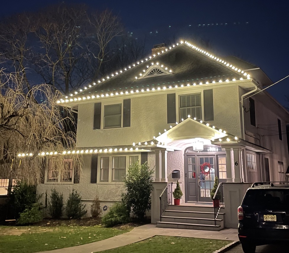 Stucco Short Hills NJ home with C9 roofline lights and a lighted front entry